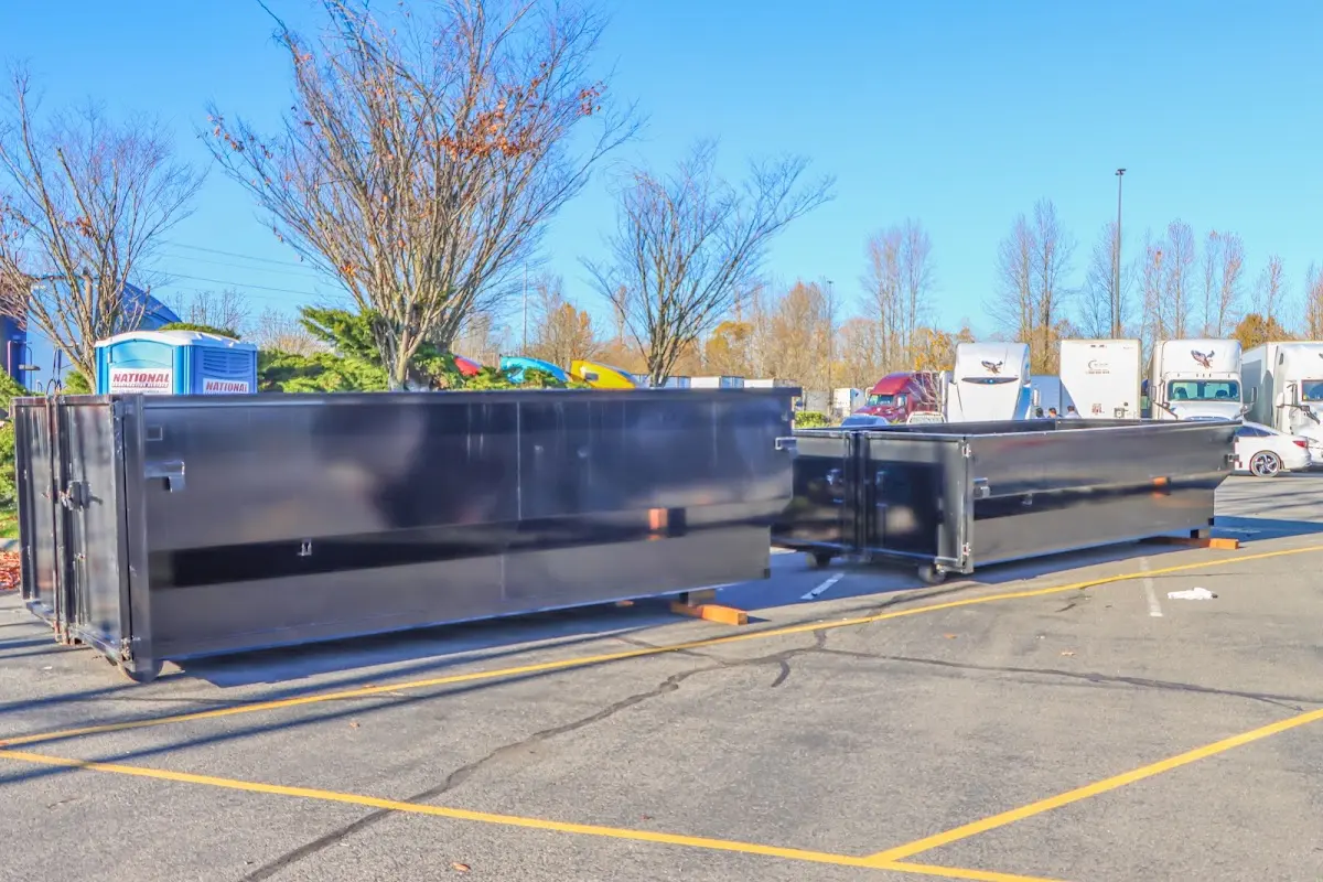 Professional dumpster rental service with roll-off container on residential driveway in West Dundee